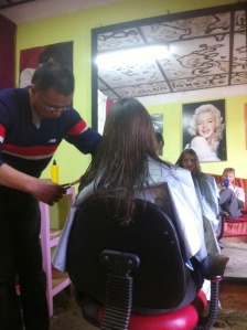 Getting her hair cut..