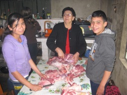 Everyone gets involved in slicing up the meat.